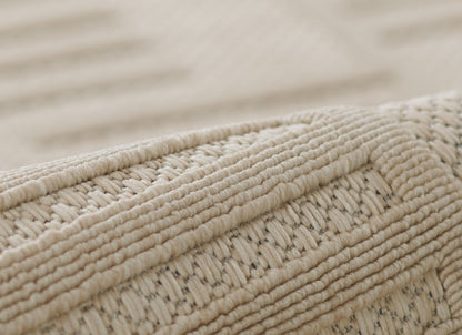 Beige natural jute rug close-up showing chunky woven fibers and braided trim.