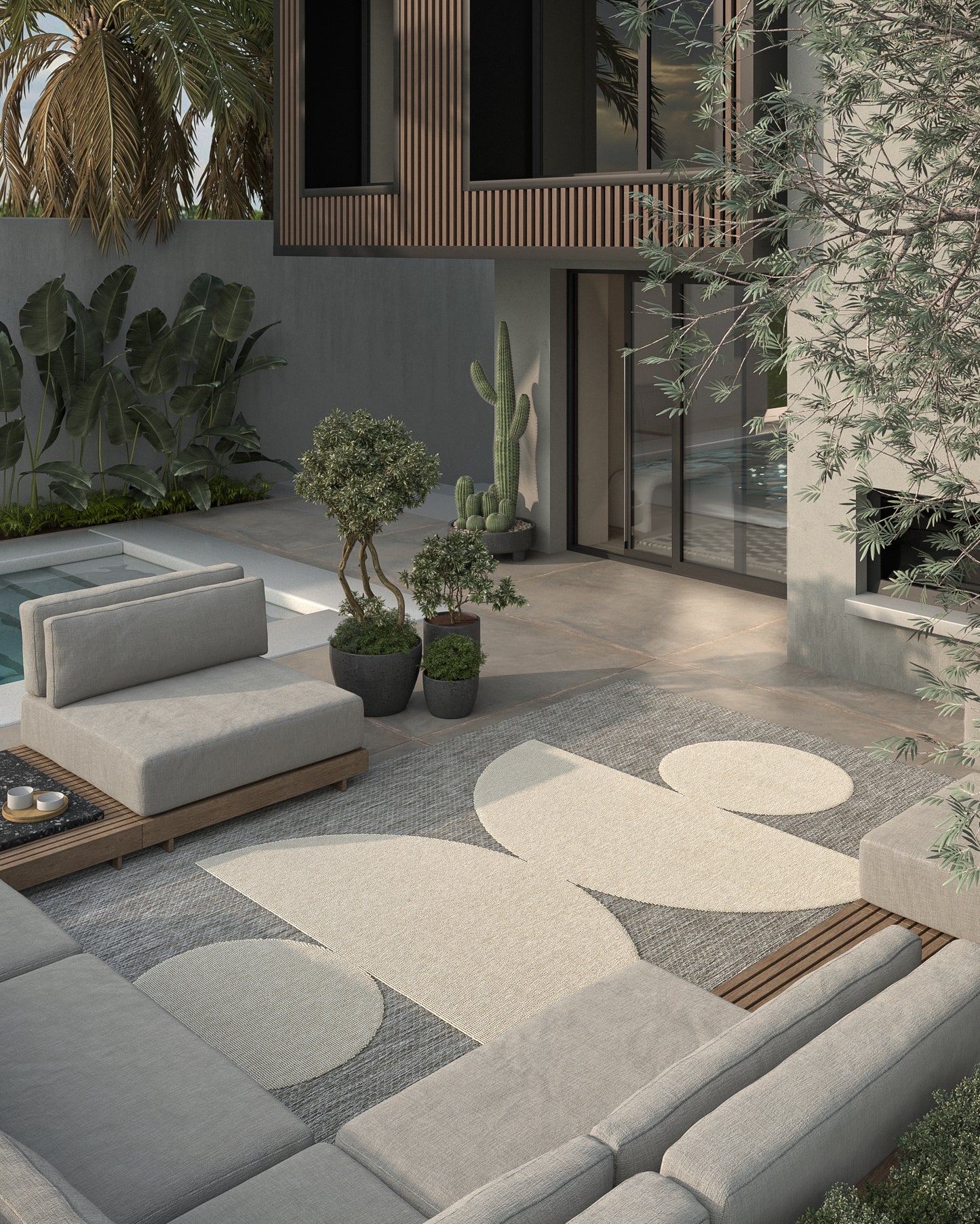 Gray outdoor rug runner on a wooden patio in a modern courtyard