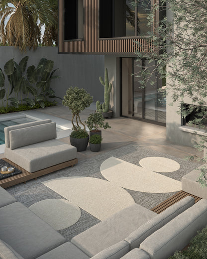 Gray outdoor rug runner on a wooden patio in a modern courtyard