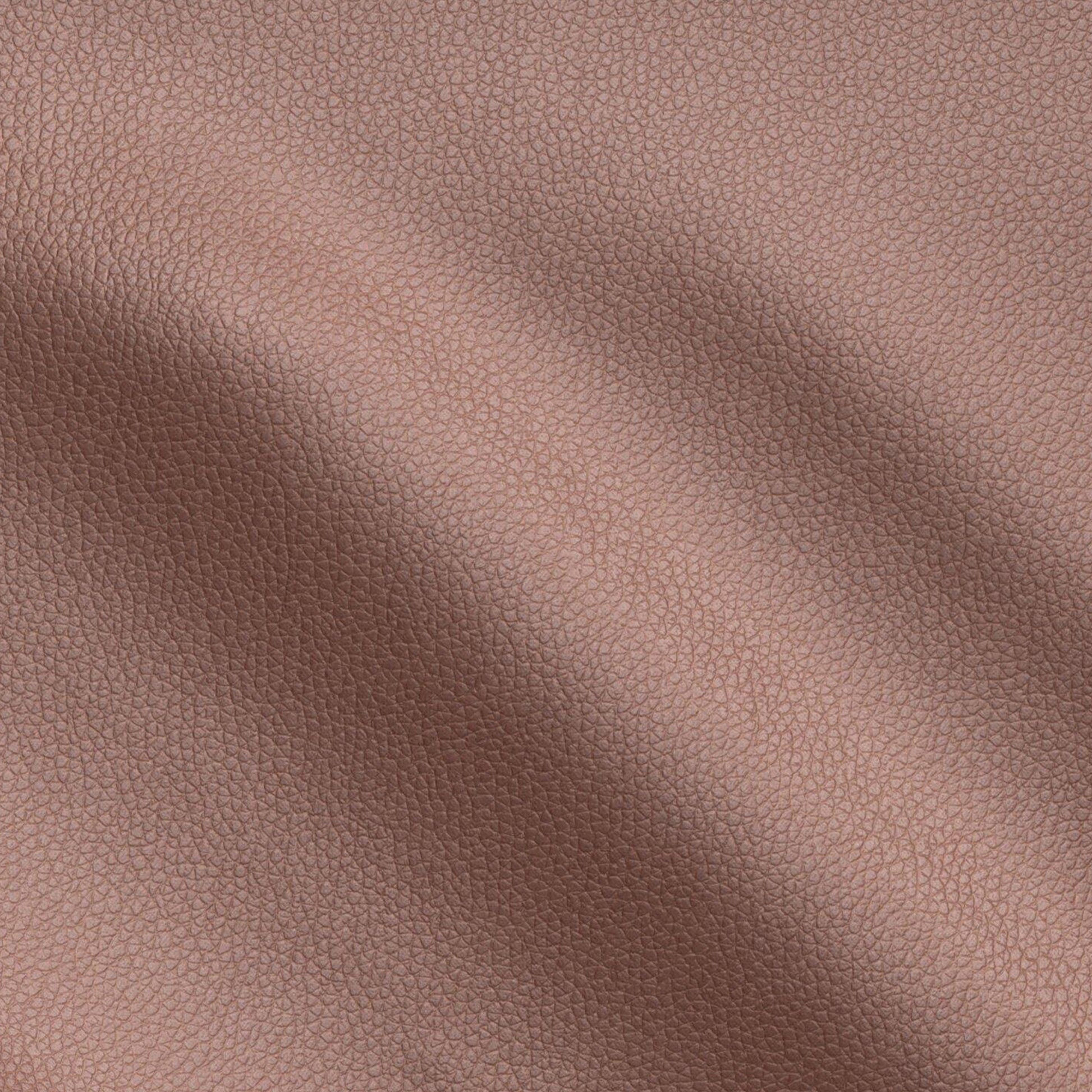Close-up of brown pebbled vegan leather texture with subtle folds and warm tan grain.