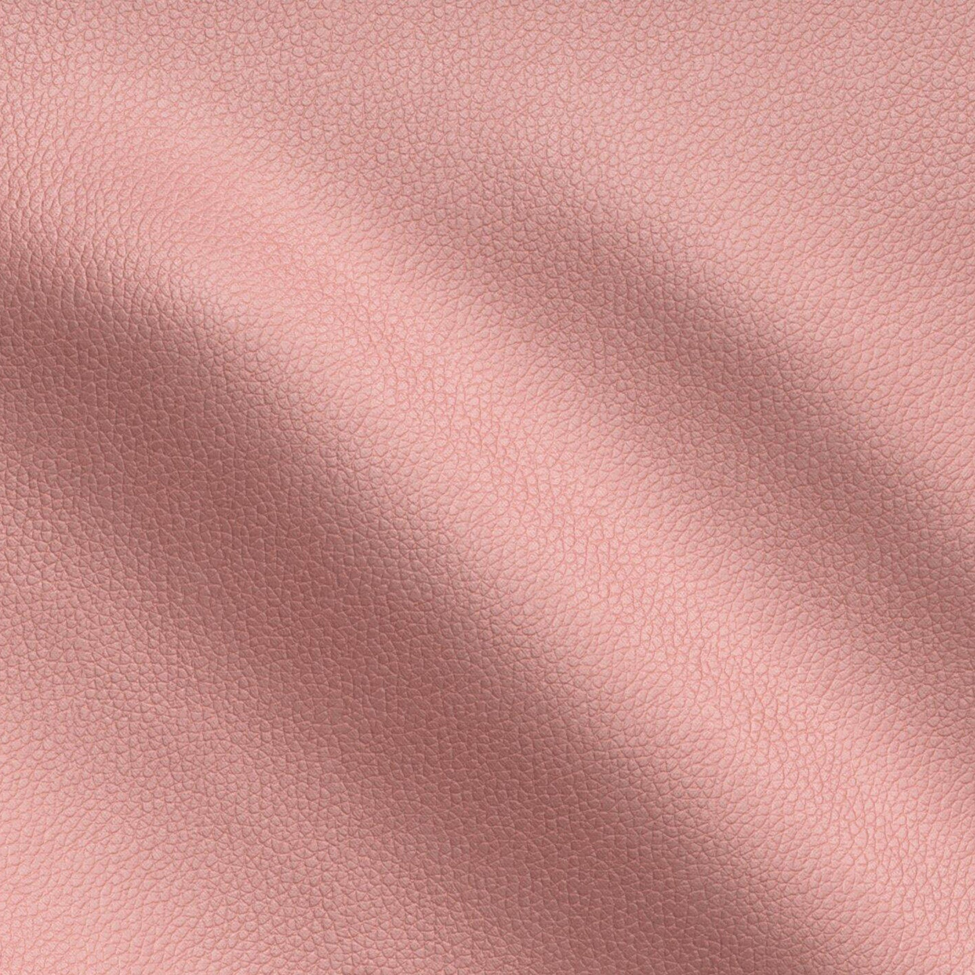 Peach pink vegan leather texture with fine grain and soft, draped folds.