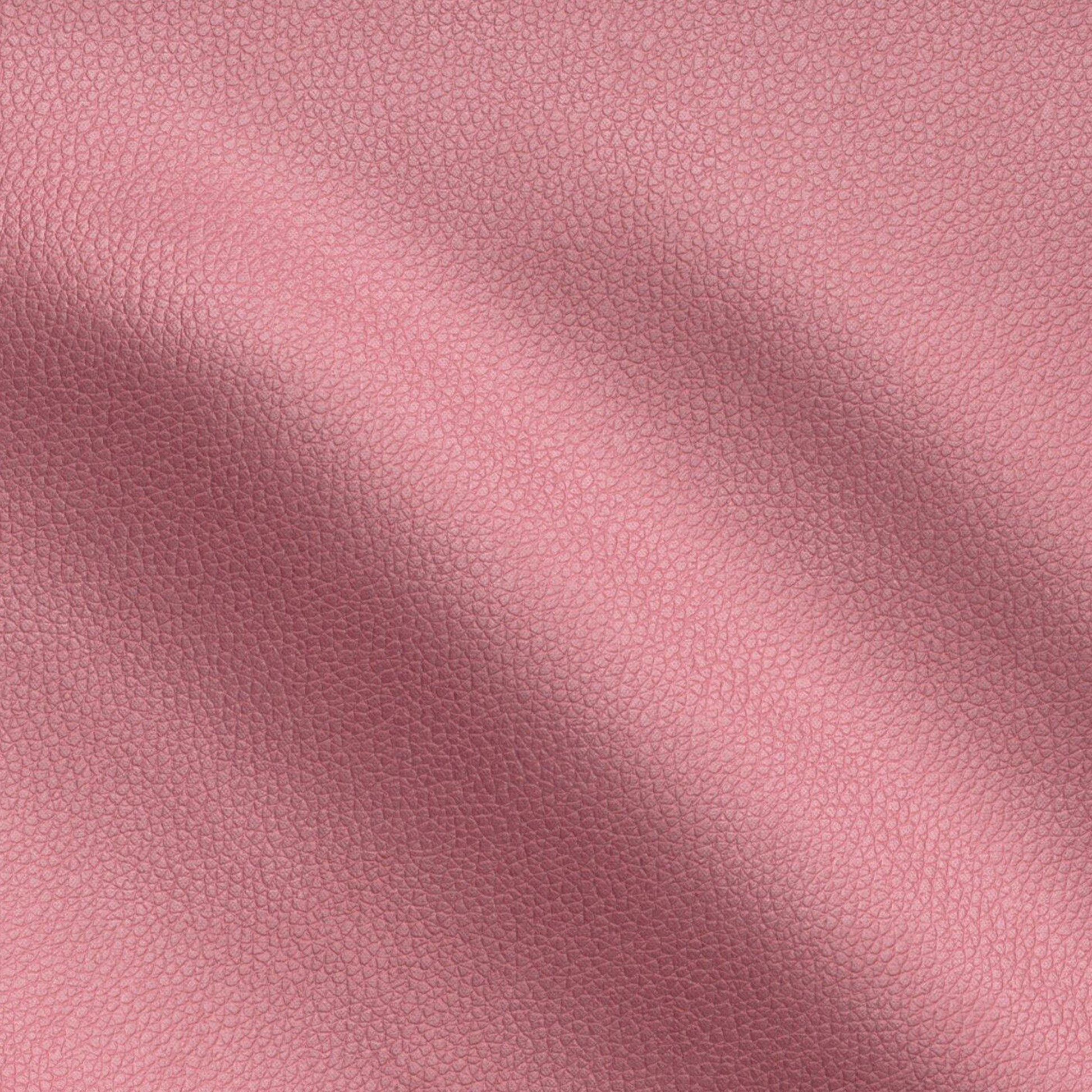 Close-up pink pebbled vegan leather texture with subtle creases.