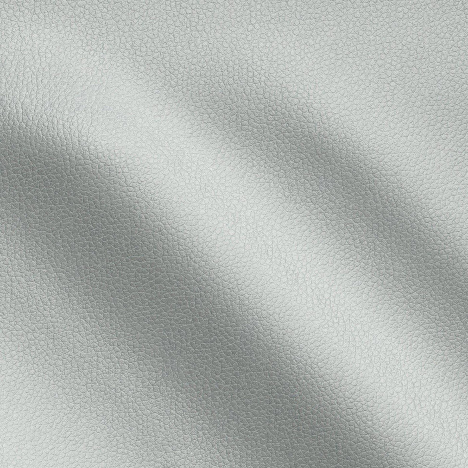 Close-up of light gray pebbled vegan leather with soft folds, a textured material for bags or upholstery.