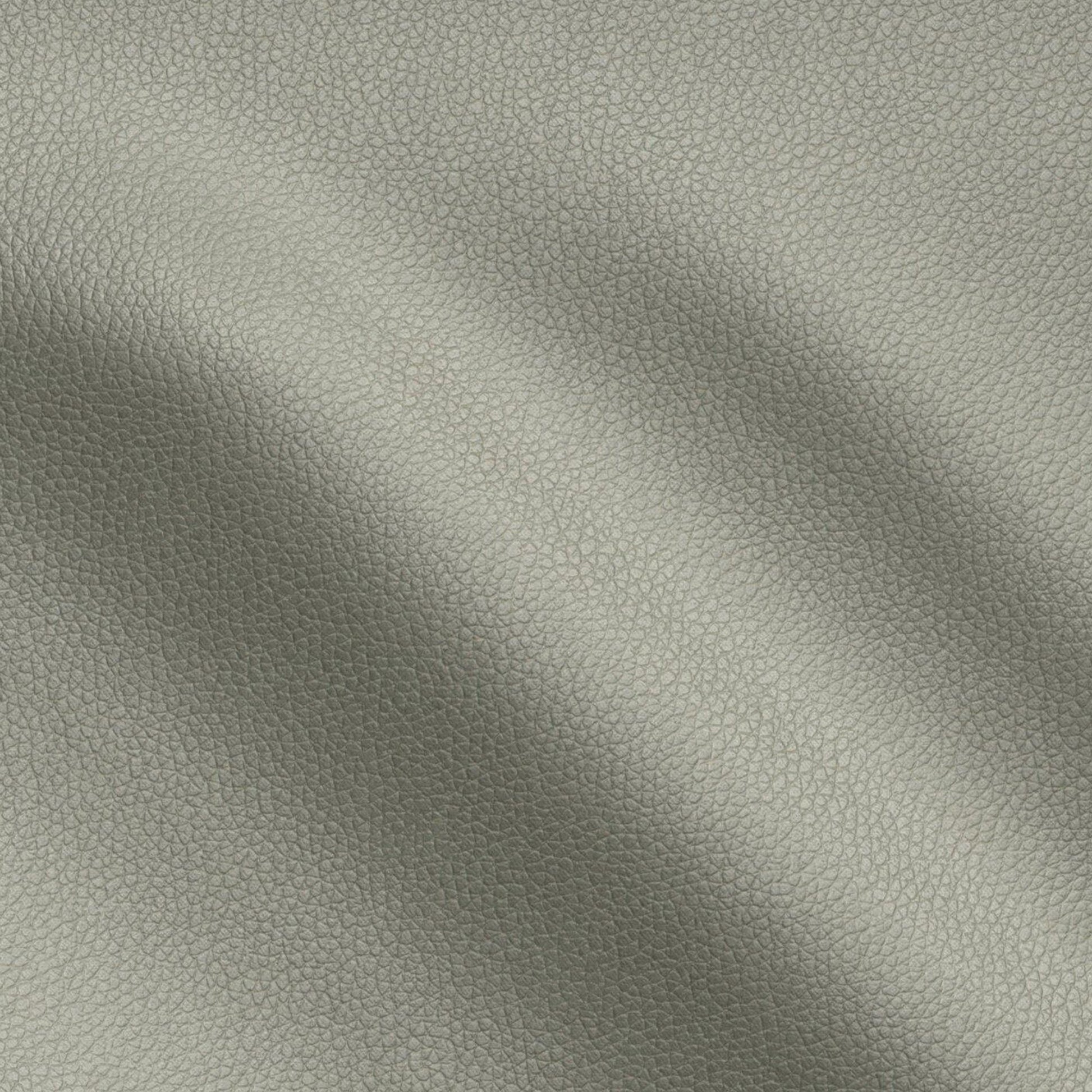 Green pebbled vegan leather vinyl fabric texture close-up with soft folds.