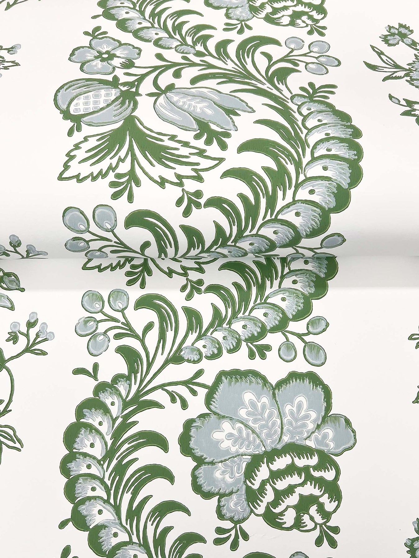 Green and gray botanical motif with curling vines and blossoms on a white background.