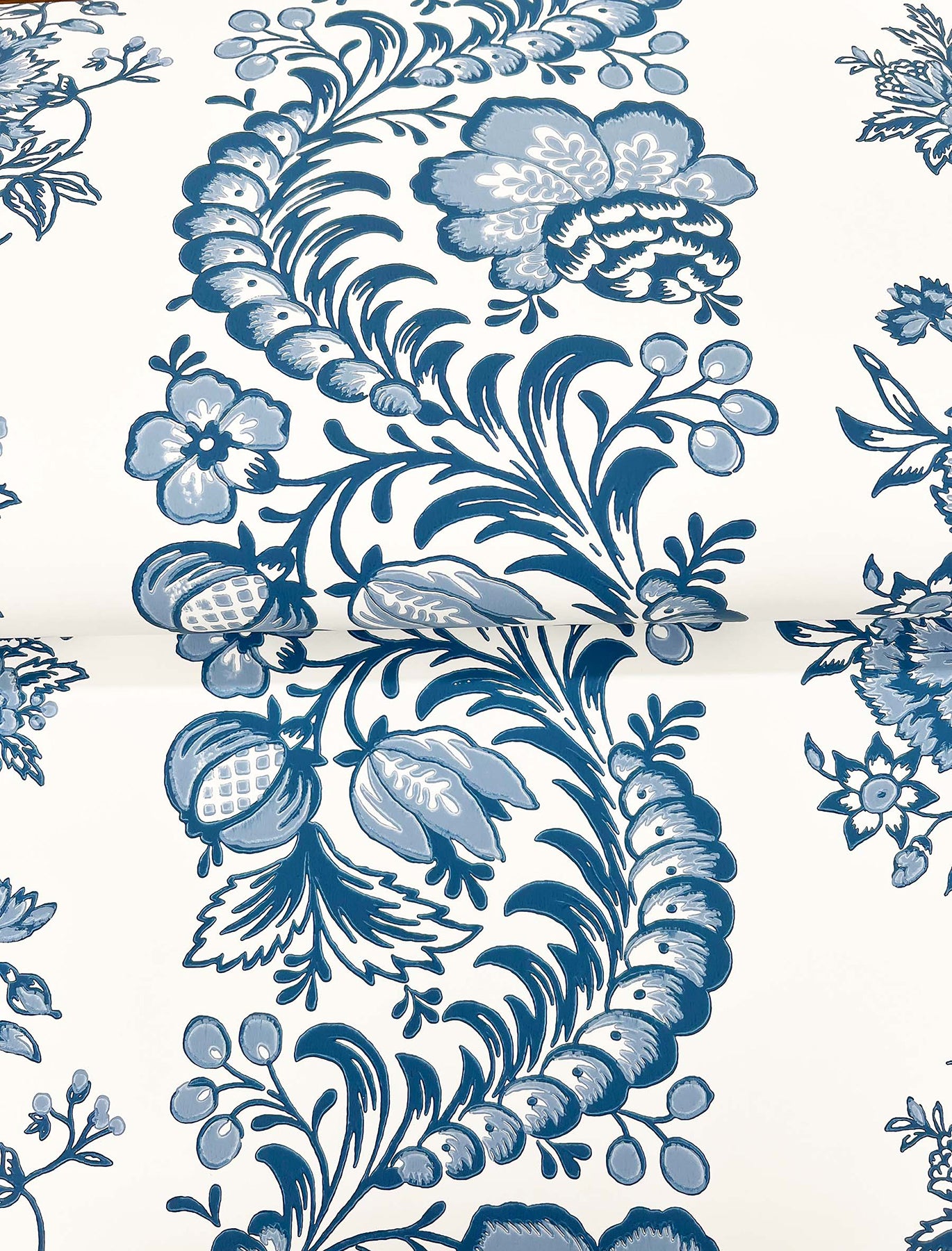 Blue and white floral stripe pattern with curling vines on ivory background; chinoiserie style wallpaper.
