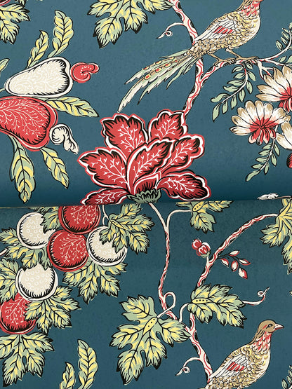 Indigo Jacobean wallpaper with a vintage botanical pattern featuring red-fruited vines, pale-yellow leaves, and perched birds.