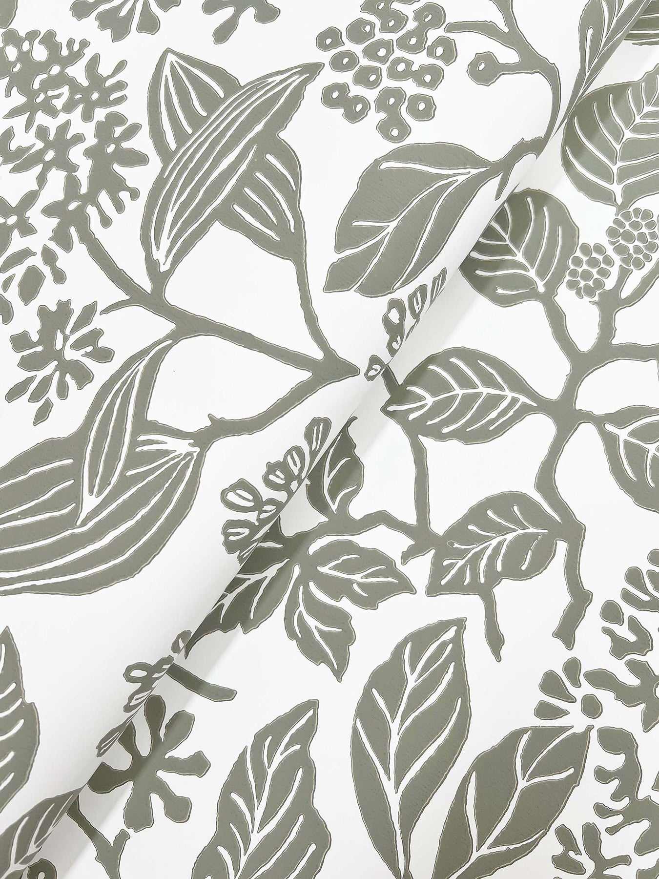 Close-up of a grey botanical wallpaper pattern with leaves, berries and branches.