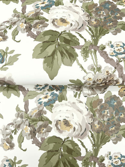Patterned fabric with white roses, green leaves, and blue-beige blossoms on cream background.