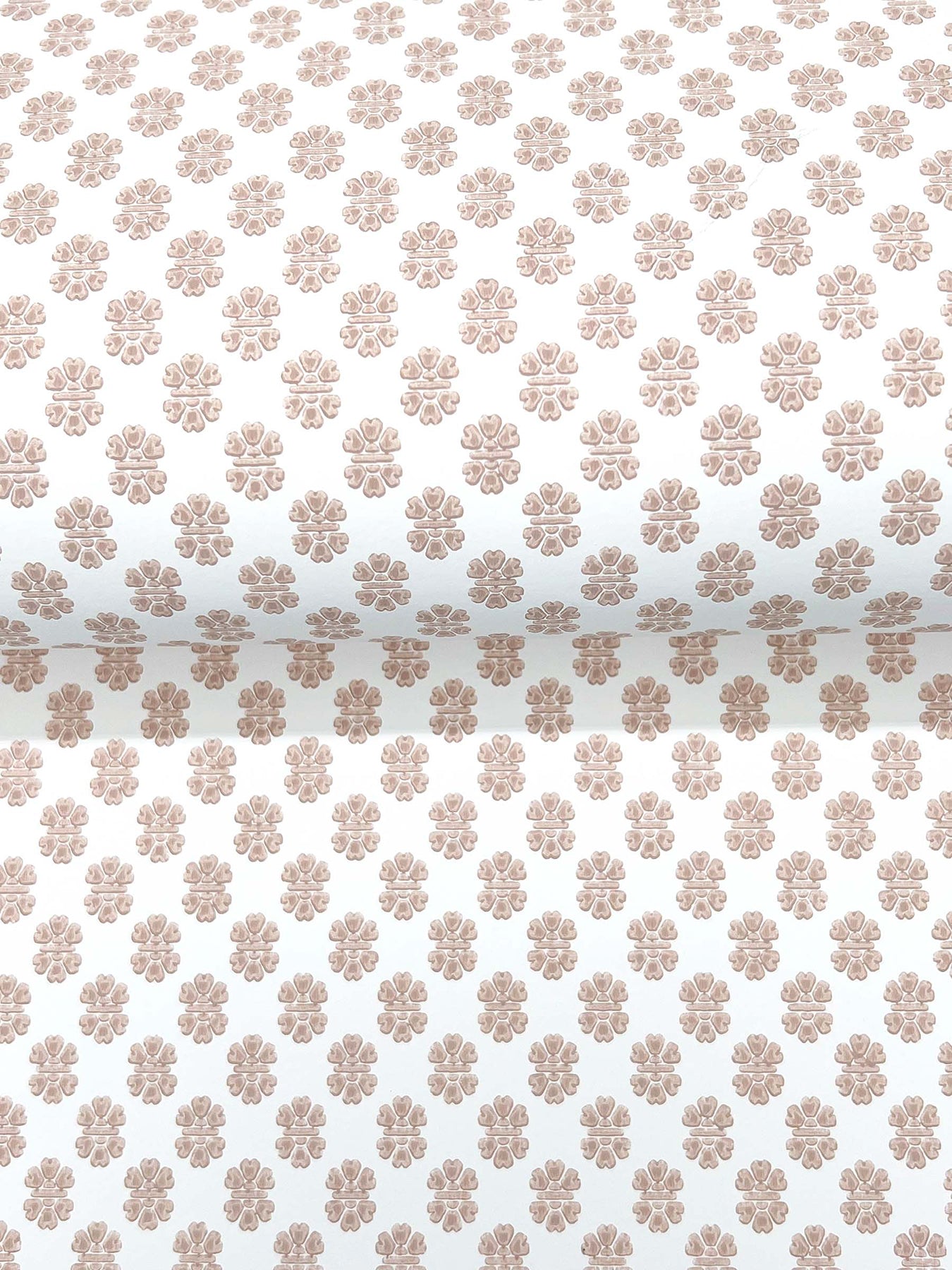 Cream fabric with repeating light copper-brown floral rosette pattern; vintage-inspired decorative textile.