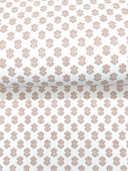 Cream fabric with repeating light copper-brown floral rosette pattern; vintage-inspired decorative textile.