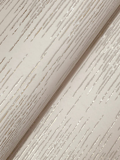 Ivory wallpaper with soft diagonal streaks and a rolled edge.