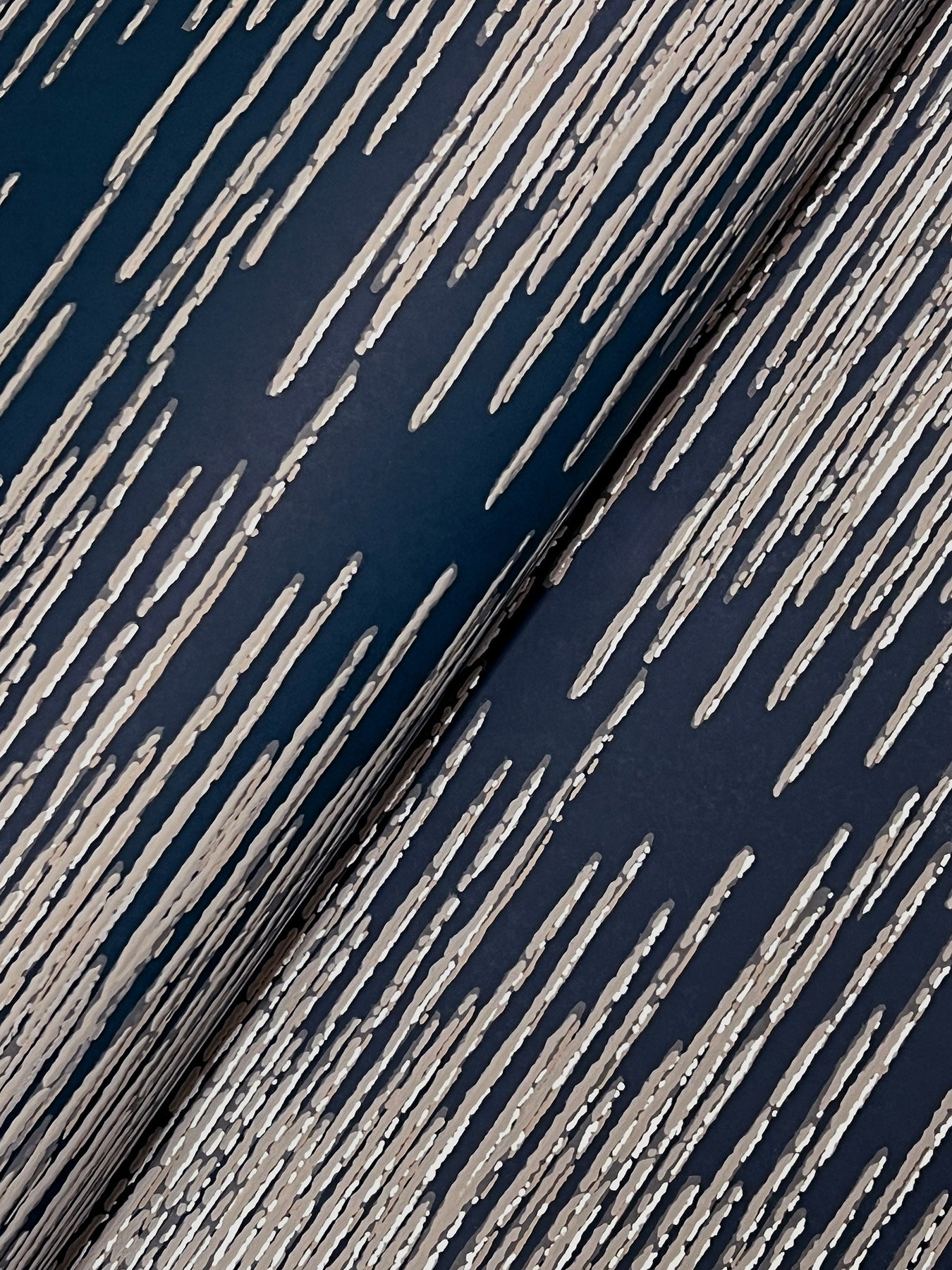 Close-up of navy blue fabric with cream diagonal streaks, creating a distressed striped pattern.