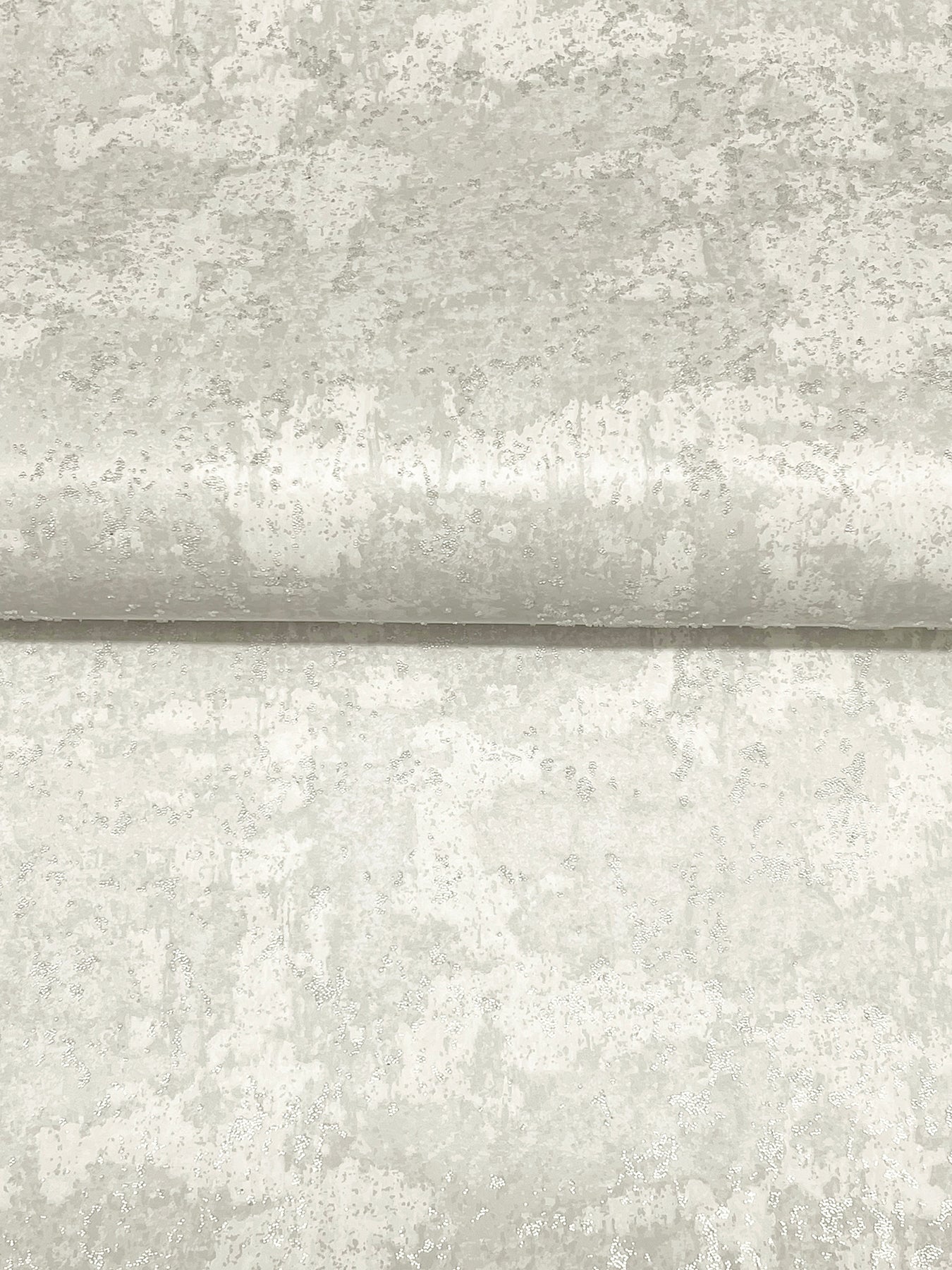 Light gray beaded wallpaper with a mottled texture and a subtle horizontal seam, featuring a dove motif.