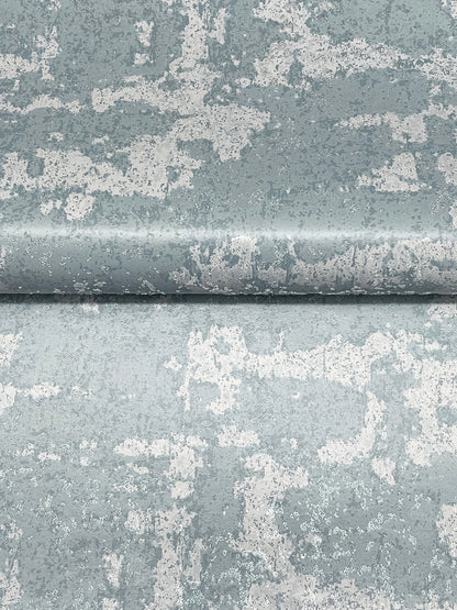 Close-up of blue-gray distressed paint with white peeling patches and a panel seam, rustic weathered texture.