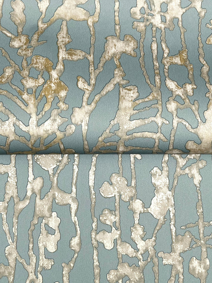 Blue-gray fabric with cream textured coral-like pattern and metallic accents; upholstery or drapery textile.