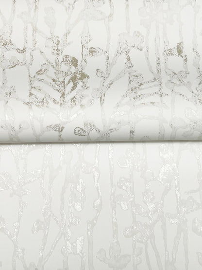 White pearl wallpaper with a subtle light gray filigree/abstract pattern and a slight metallic sheen, rolled edge visible