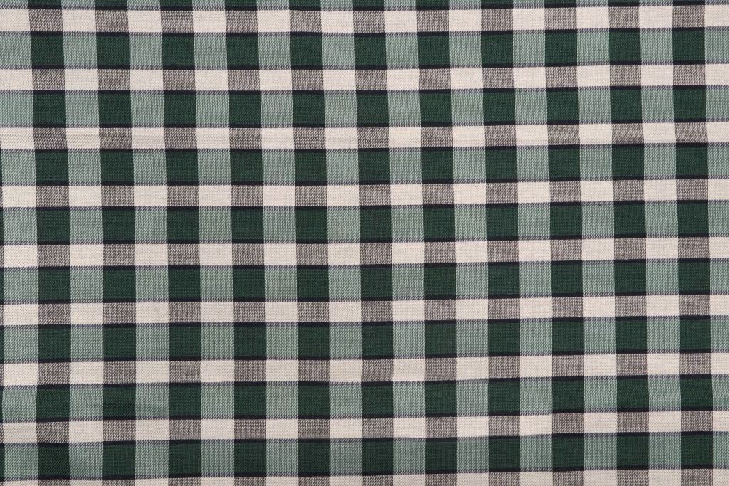 Green and black plaid fabric swatch; woven textile for clothing or home decor.