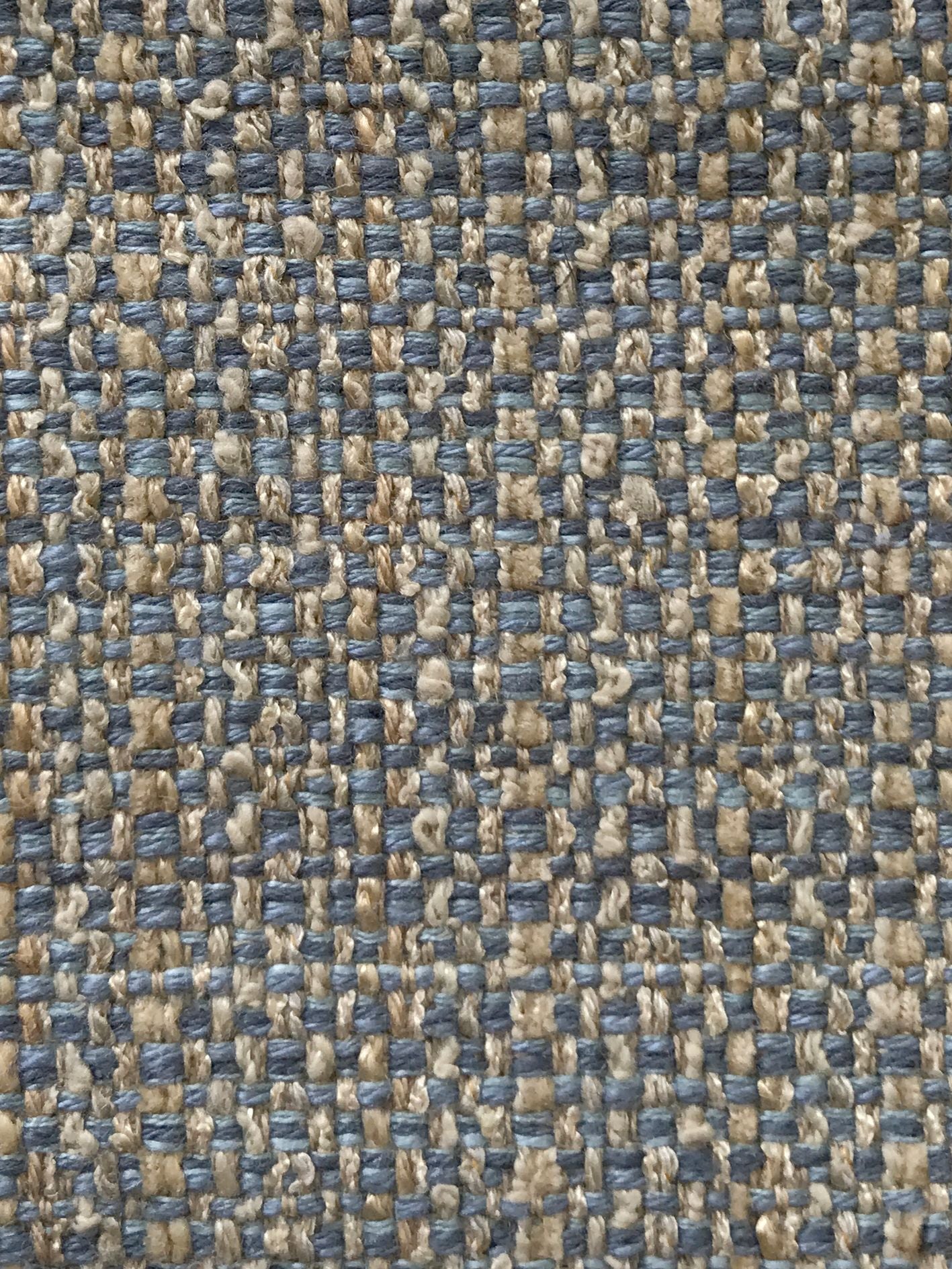 Close-up of blue and beige woven fabric with a tight checker-like grid, suitable for rug or upholstery.