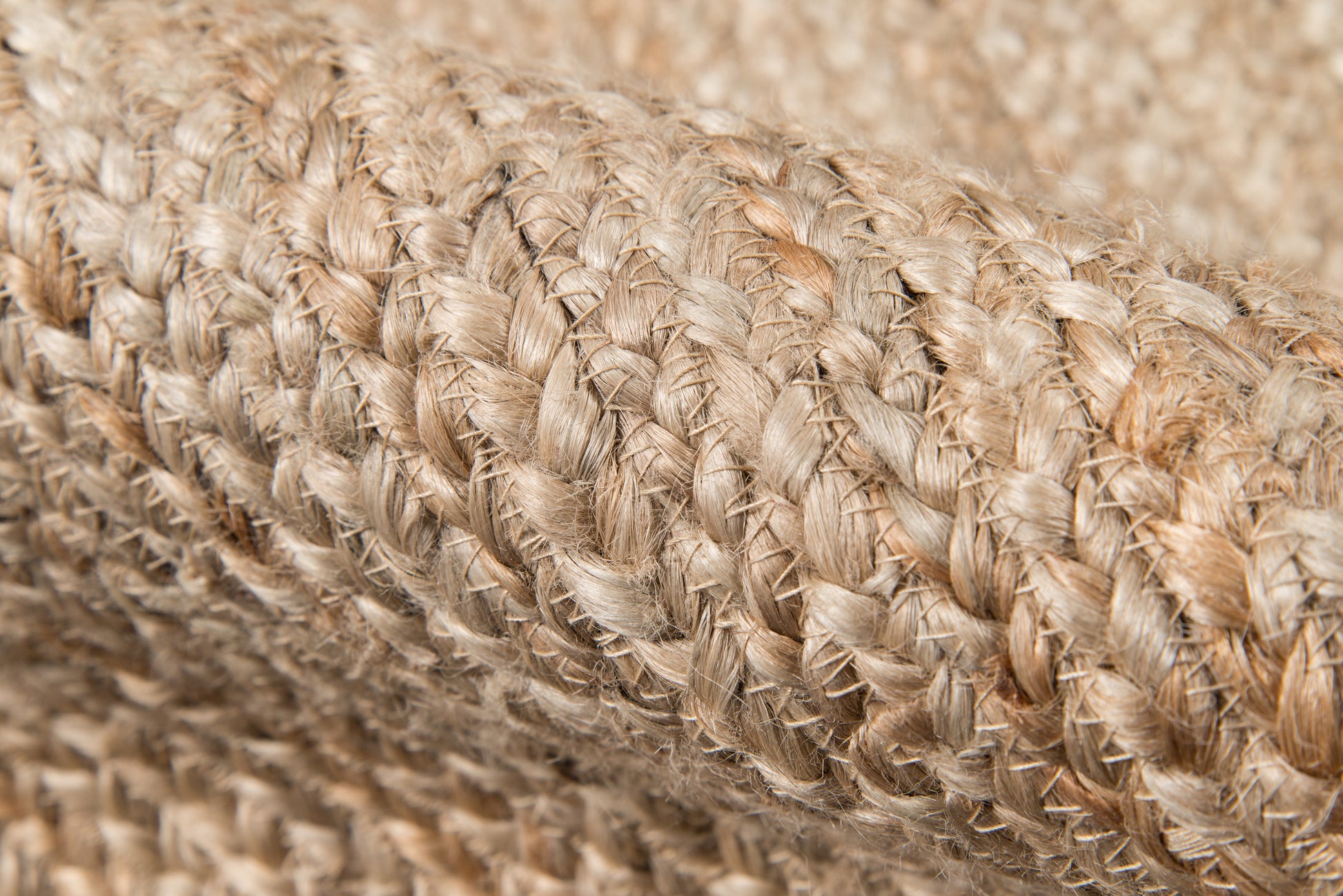 Close-up of natural tan braided fibers forming a rustic woven rug texture; 2' x 8' runner.