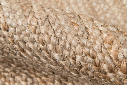 Close-up of natural tan braided fibers forming a rustic woven rug texture; 2' x 8' runner.