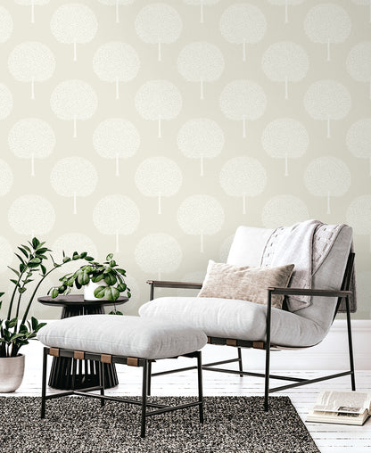 Pale gray wallpaper with a botanical tree-pattern design on the wall; interior scene.