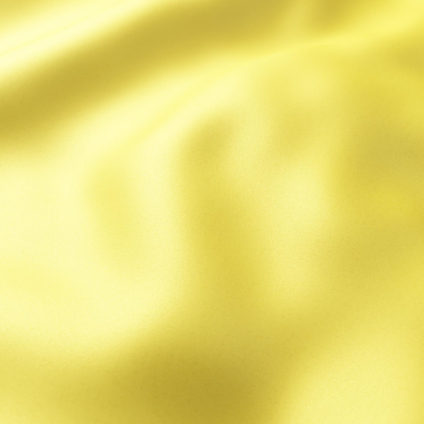 Bright yellow plain-sateen fabric close-up with soft folds and a satin-like sheen.