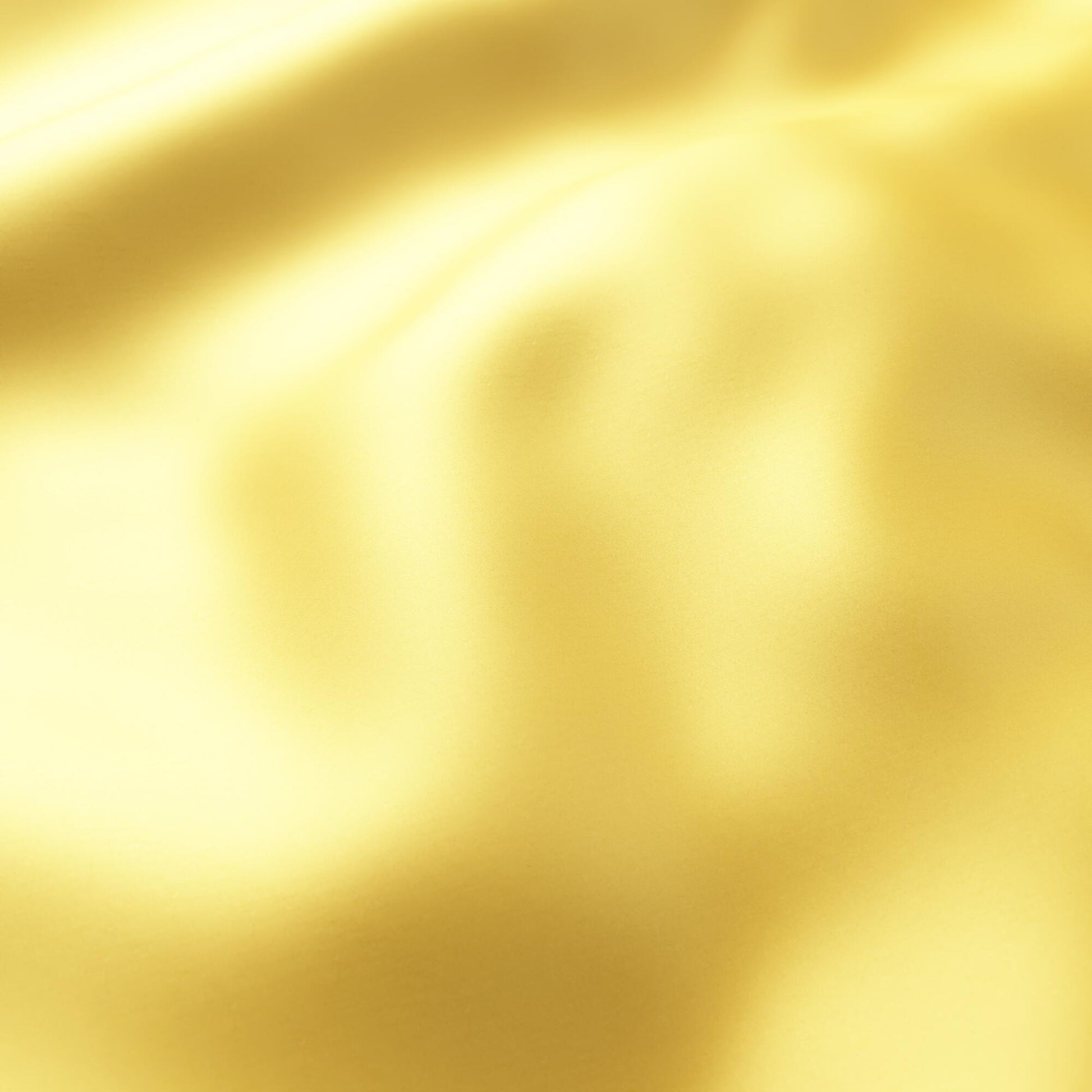 Close-up of yellow sateen fabric with soft drape and glossy sheen