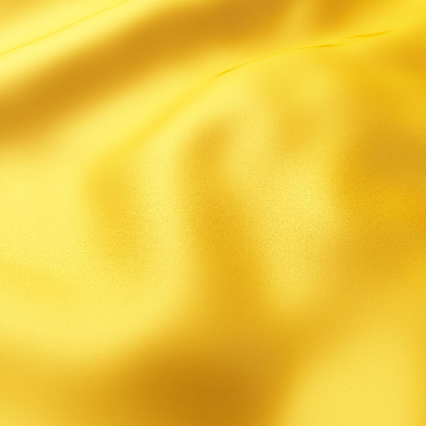 Close-up of bright orange-gold sateen fabric with soft folds and smooth sheen.