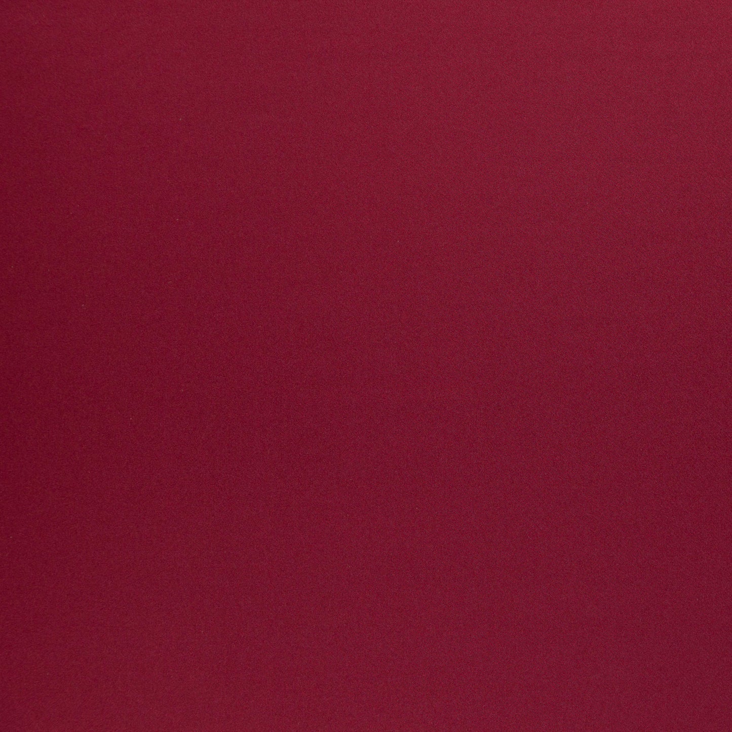 Solid burgundy fabric with soft velvety texture, rich color for upholstery or garments.