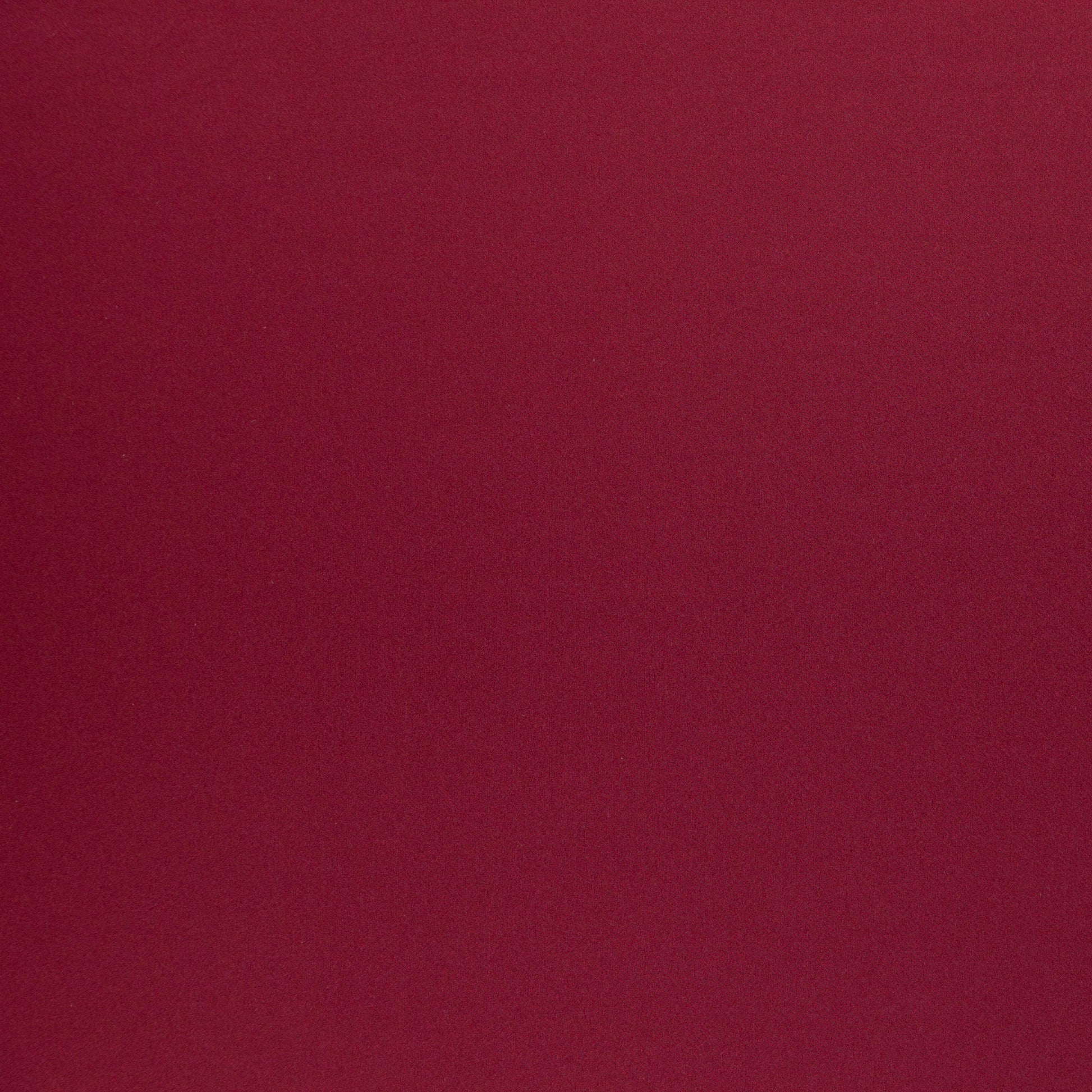 Solid burgundy fabric with soft velvety texture, rich color for upholstery or garments.