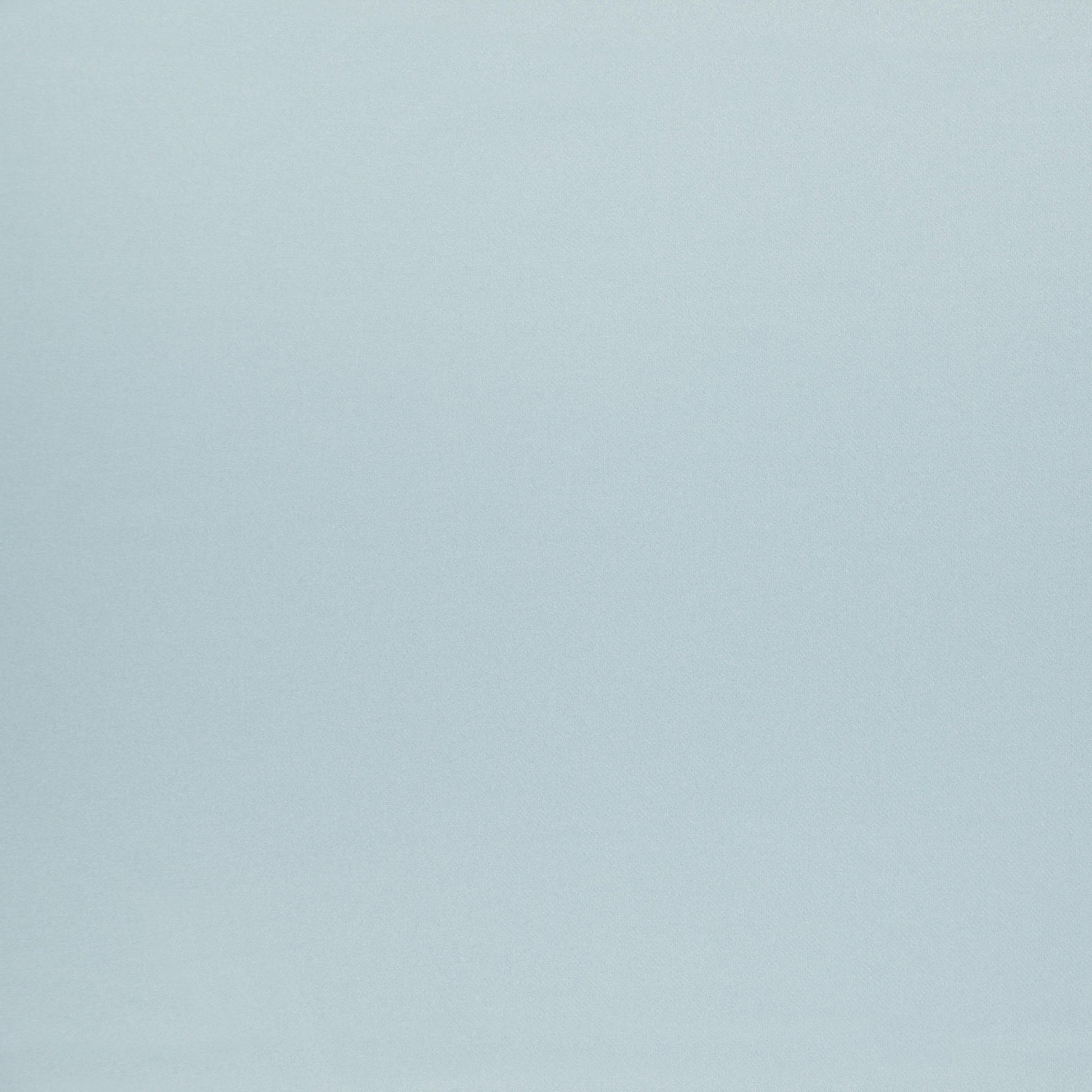 Soft pale blue fabric backdrop with subtle texture.