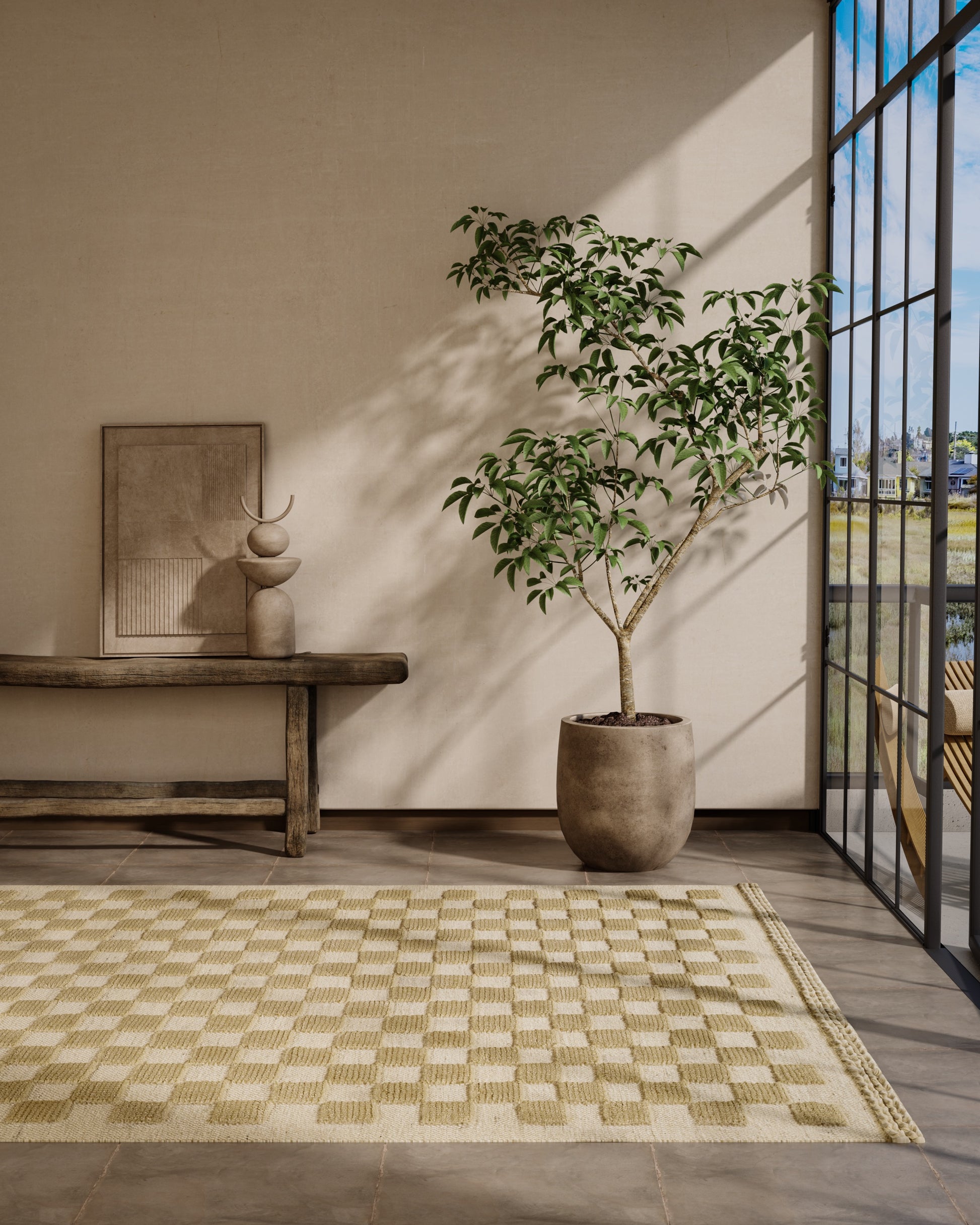 Neutral living space with a potted indoor tree in a round clay pot, wooden bench, cream-and-beige checkered rug, and glass wall view.