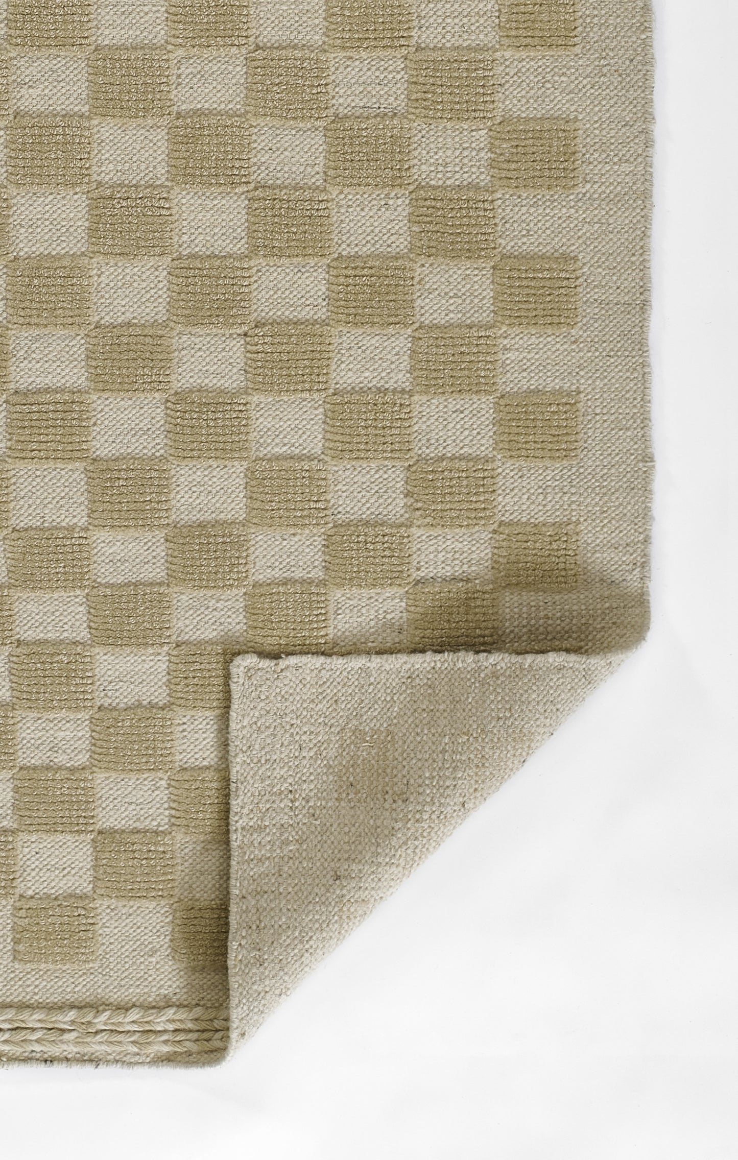 Beige checkerboard woven rug in light and medium beige tones; flatweave with folded corner showing underside.