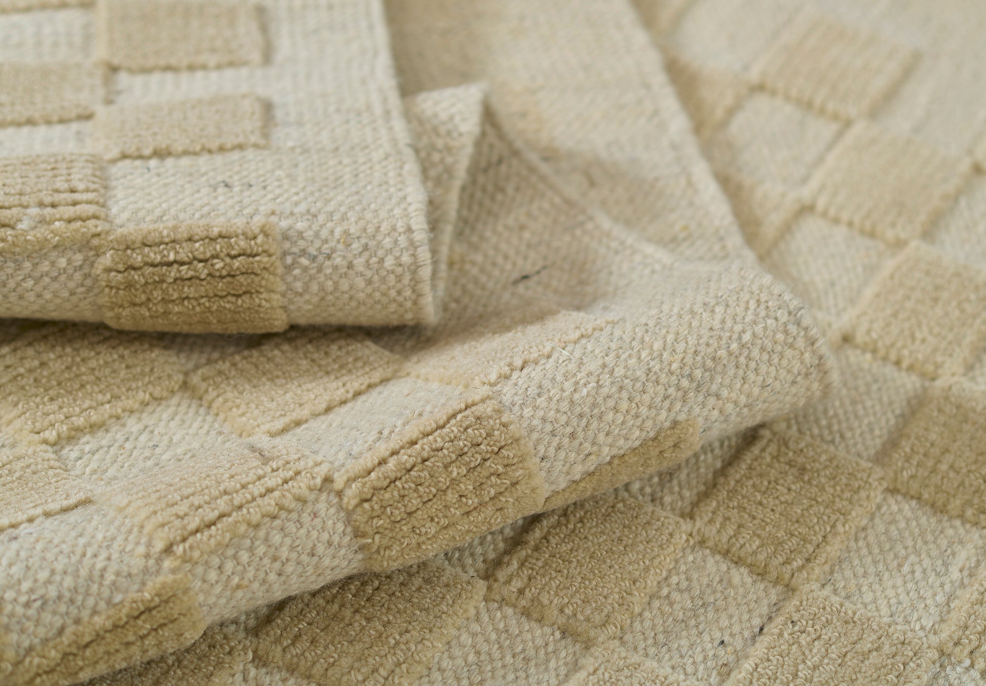 Beige rug with a cream checkerboard pattern; plush woven area rug, 9' x 12'.