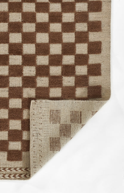 Brown and beige checkerboard woven runner rug; rectangular with folded corner exposing lighter underside.