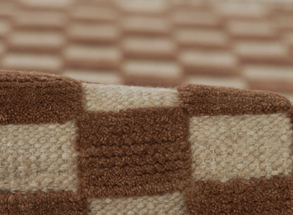 Brown and beige checkered rug with soft boucle texture.