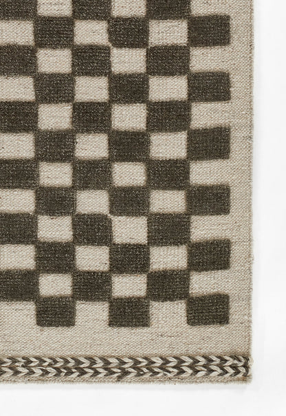 Beige woven rug with a dark brown checkerboard grid and a black-and-tan chevron border along the bottom.