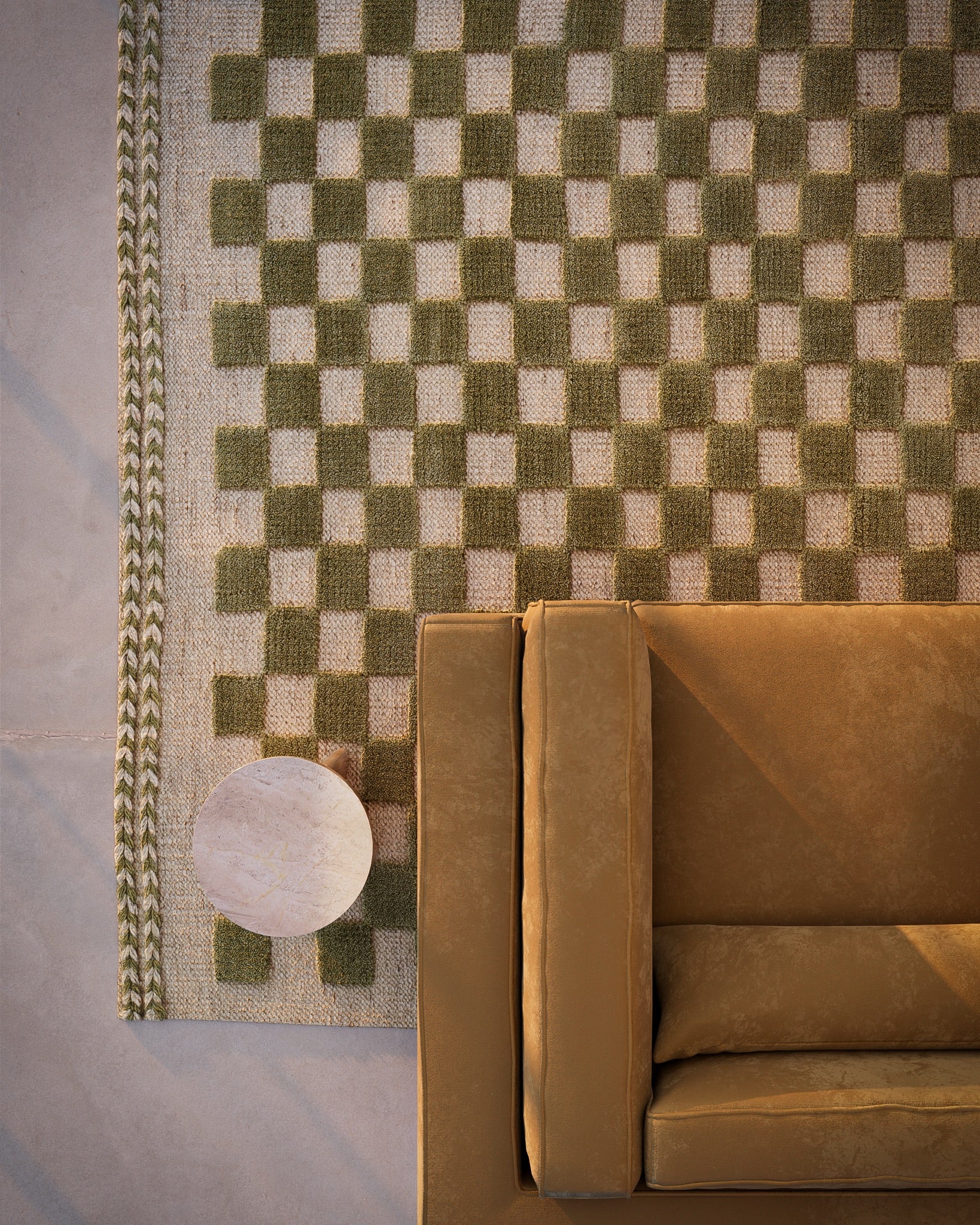 Green and beige checkered rug with a braided border, 5' x 8'.