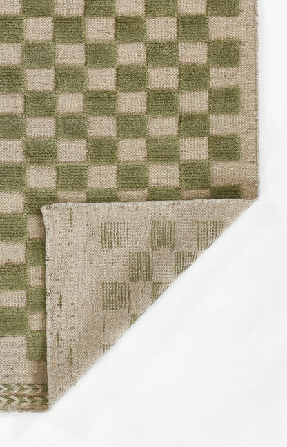 Olive green and beige checkerboard woven rug with folded corner revealing lighter underside.