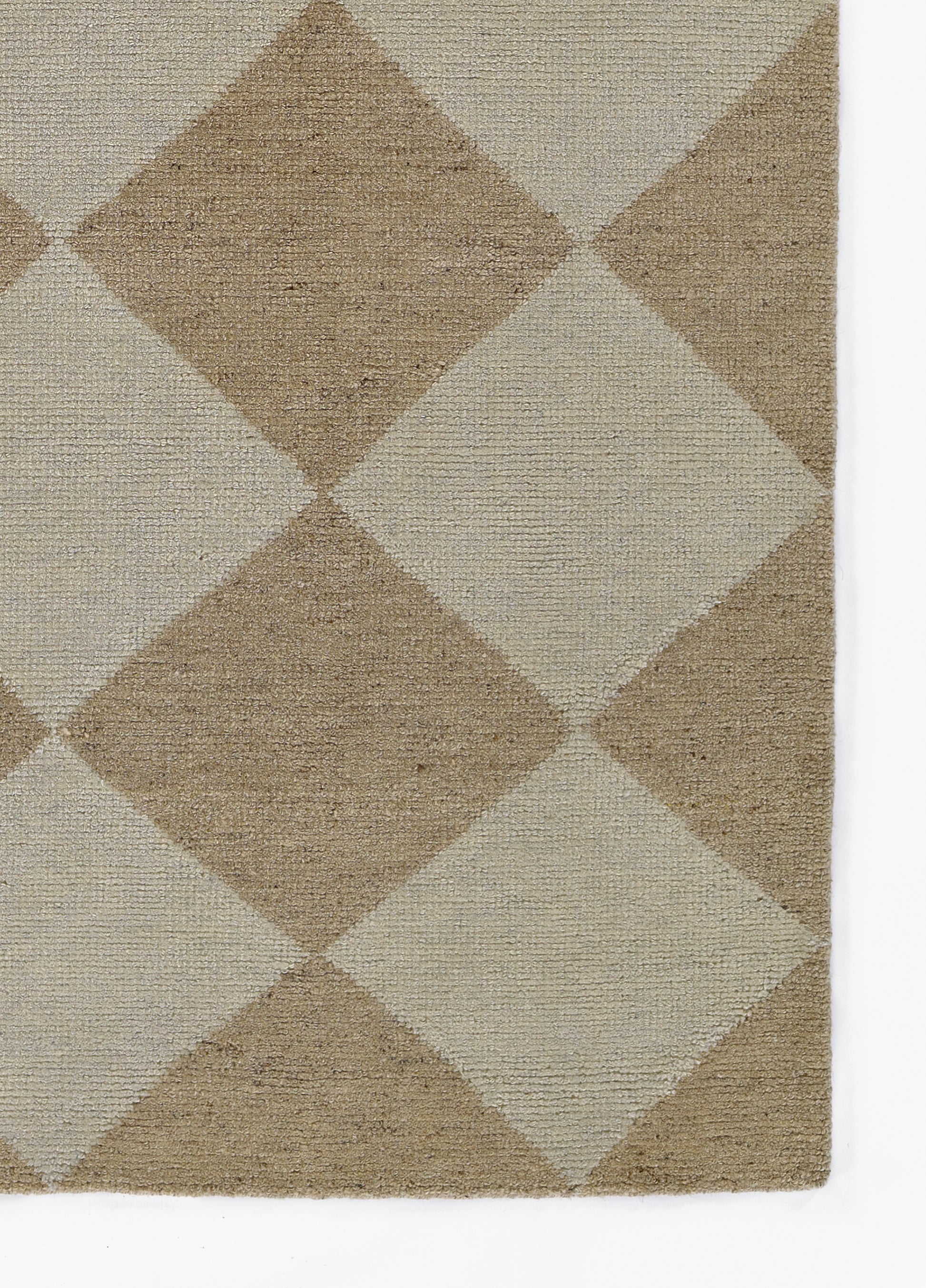 Rectangular woven area rug with tan and cream diamond pattern and textured weave.