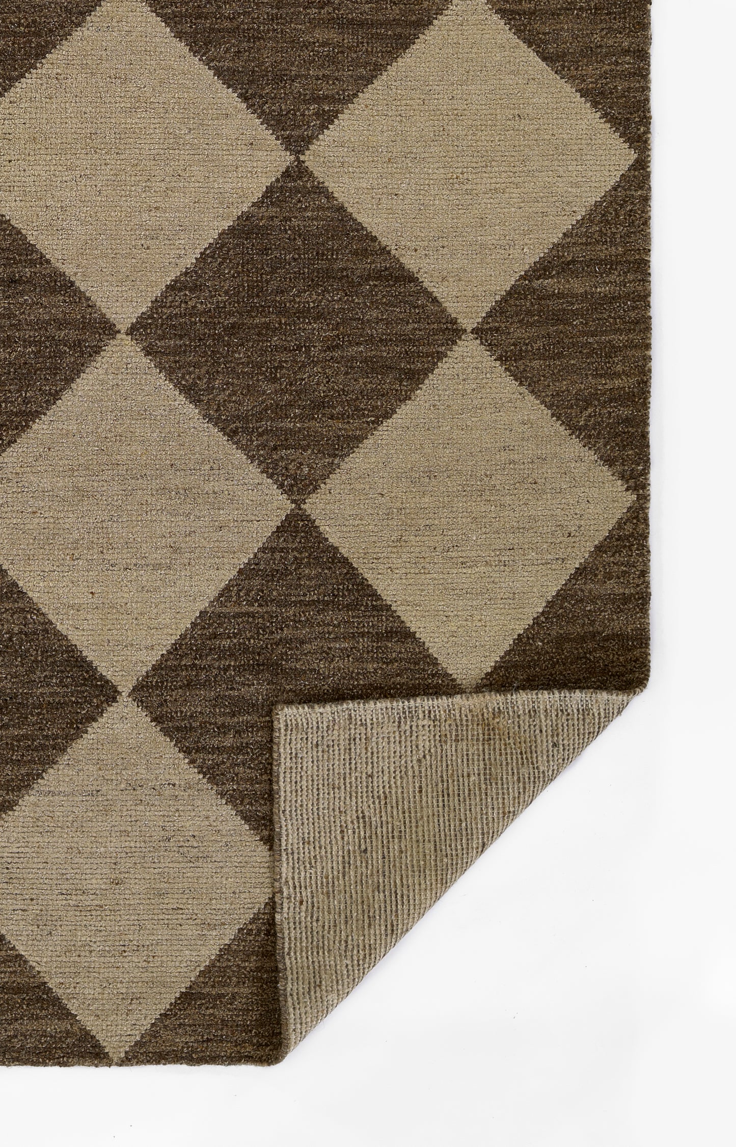 Brown and beige diamond-pattern area rug with woven texture; rectangular, folded corner reveals underside.
