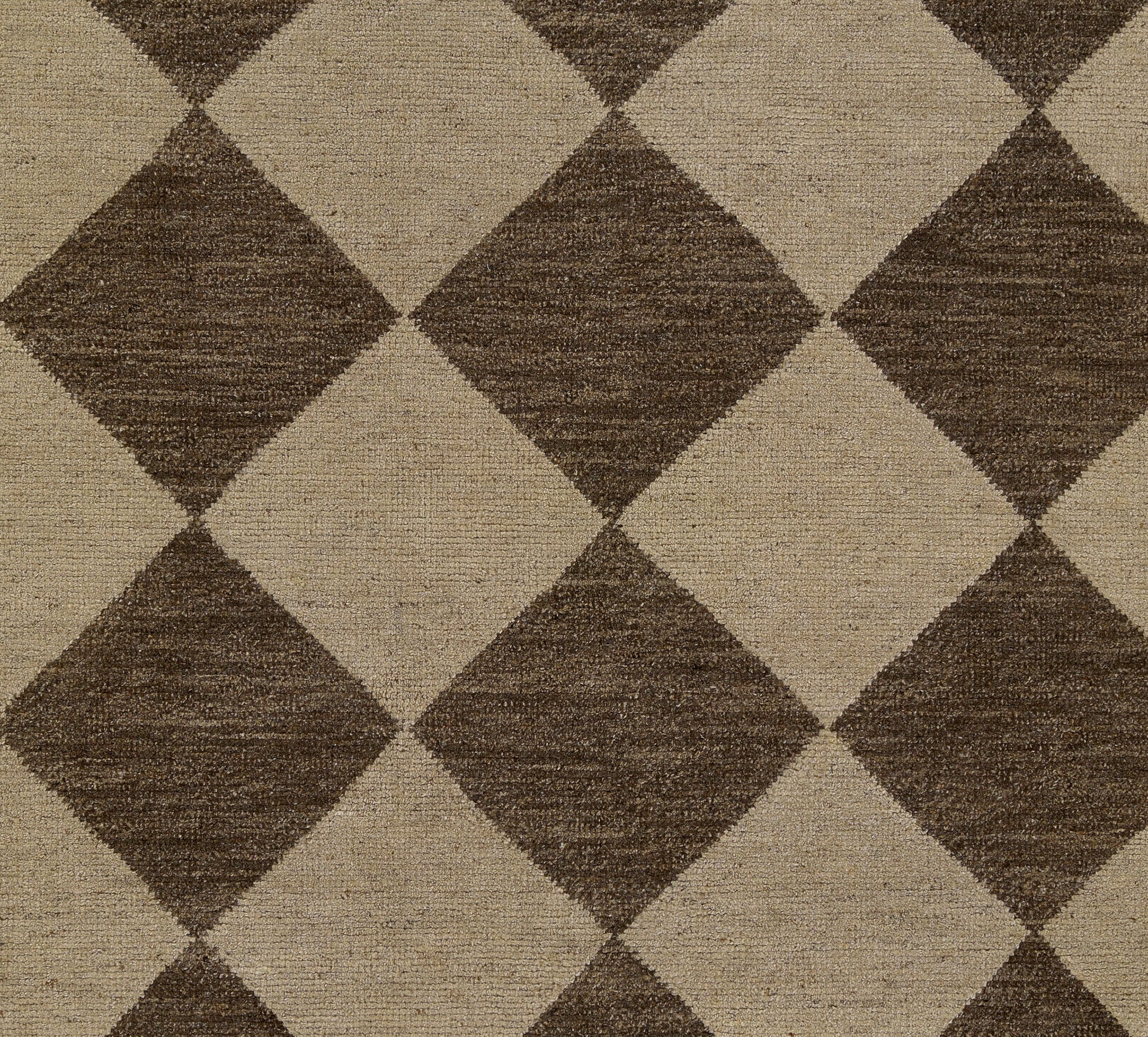 Brown and tan diamond-pattern rug with a woven texture; geometric, neutral decor.