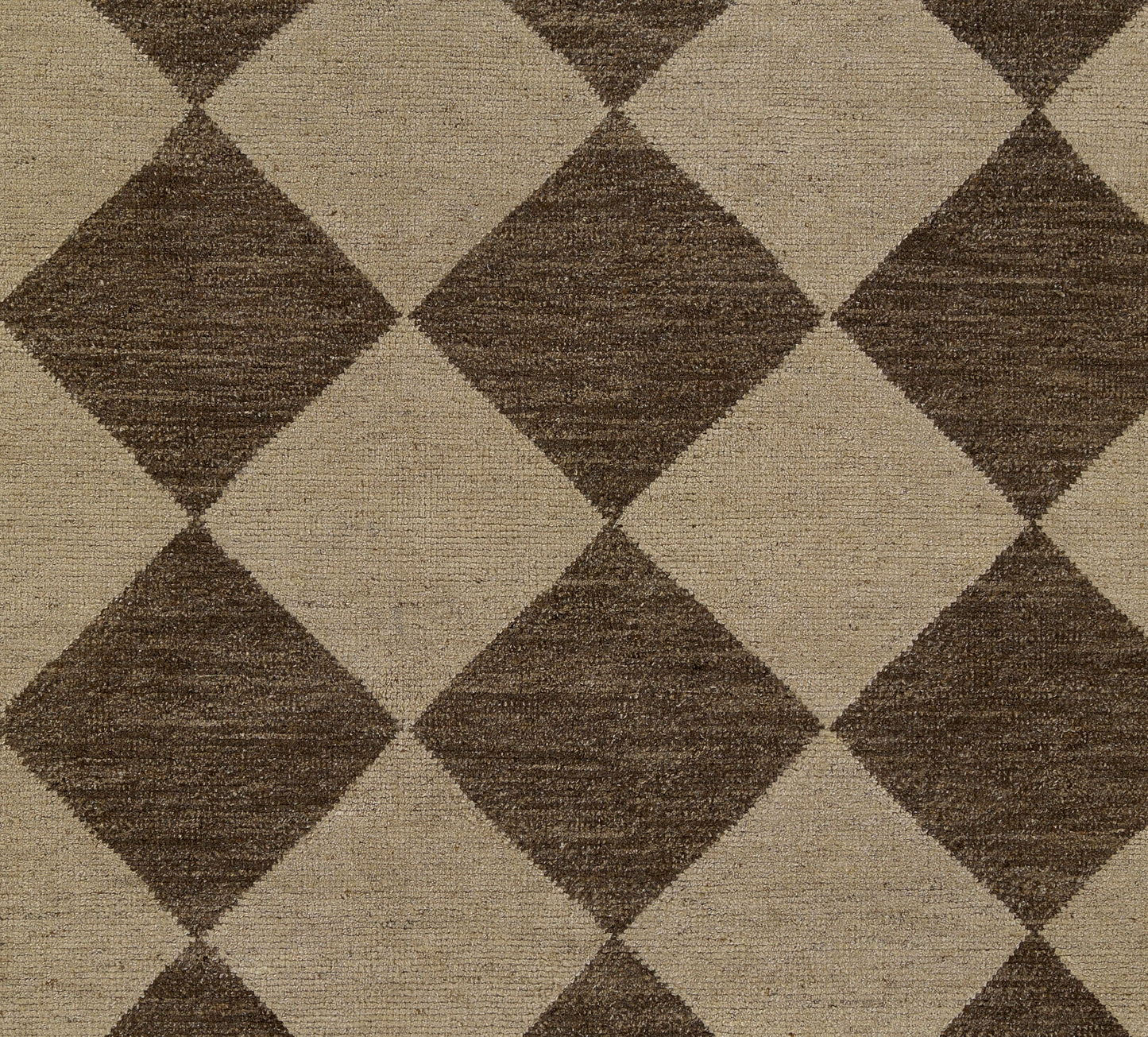 Brown and beige diamond-patterned area rug with a woven texture; bold geometric diamond design.