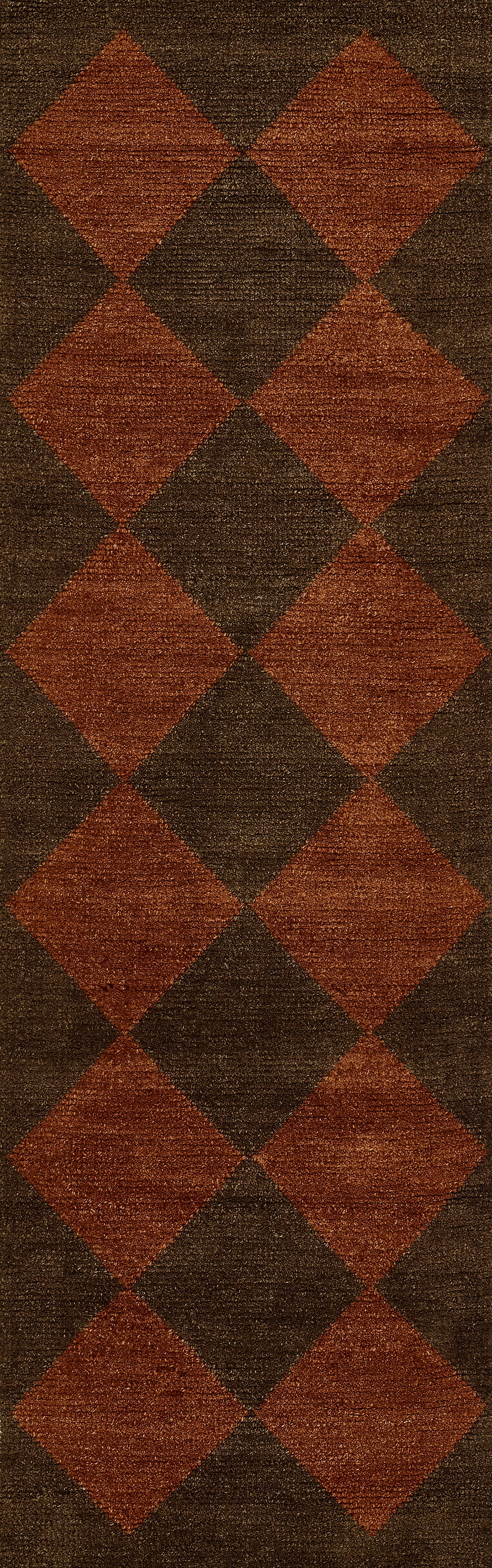 Large rectangular rug with a rust-orange diamond argyle pattern on a dark brown background.