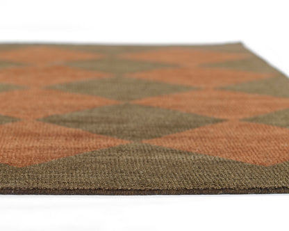 Flat-weave rug featuring an orange and olive diamond pattern with a kilim-style woven texture.