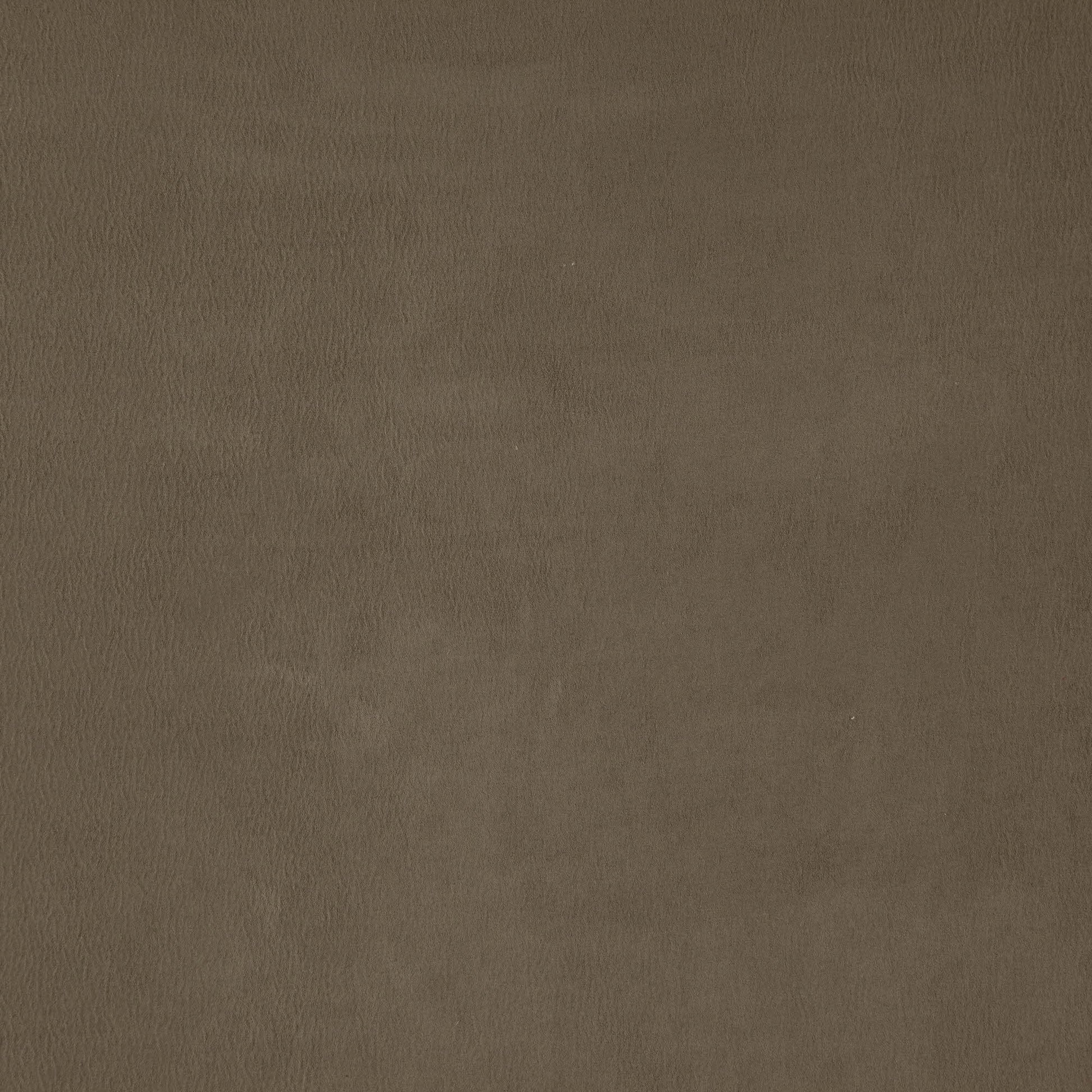 Brown faux suede fabric texture close-up with subtle grain and warm tan finish