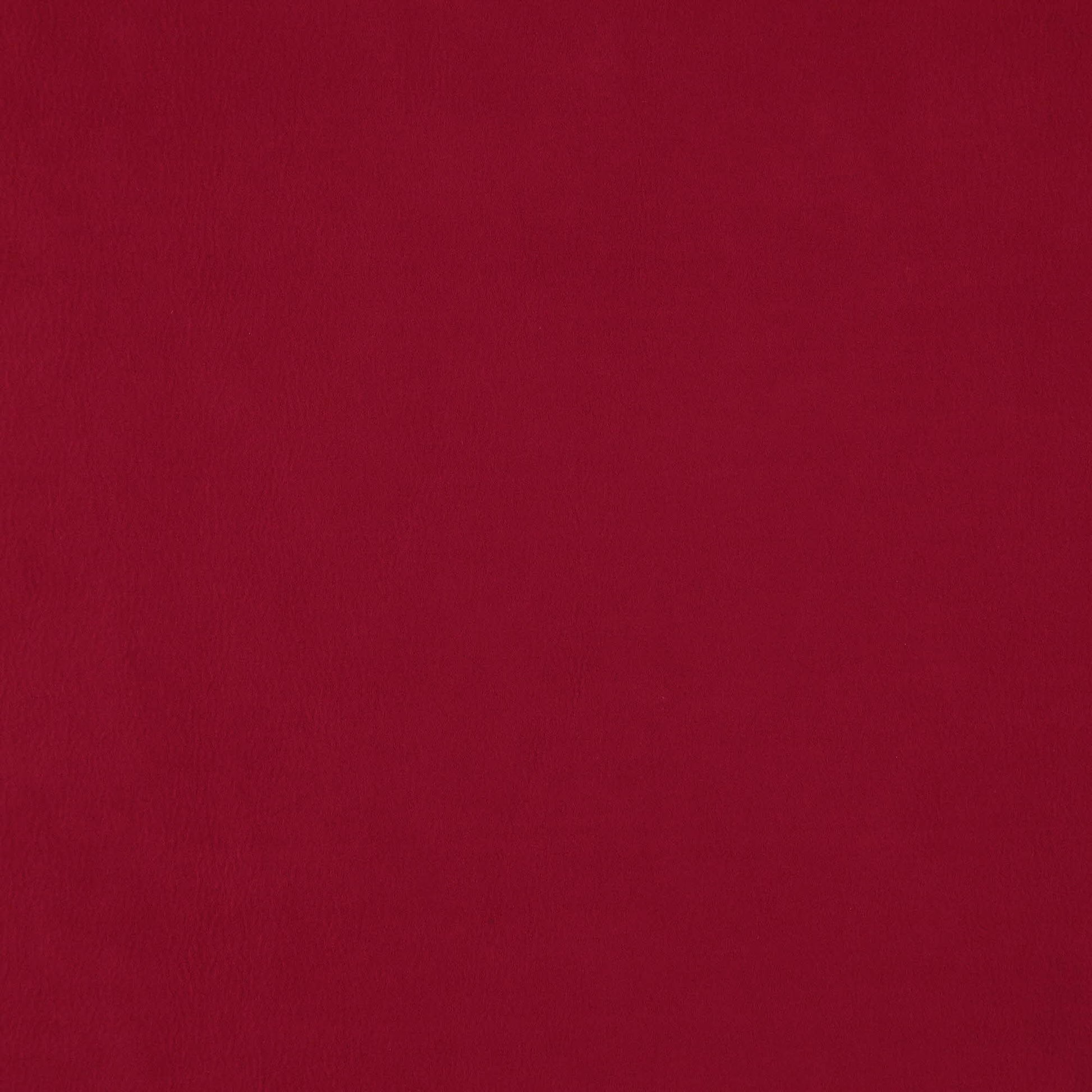 Solid deep red faux suede fabric with a soft textured nap, versatile for upholstery or fashion.