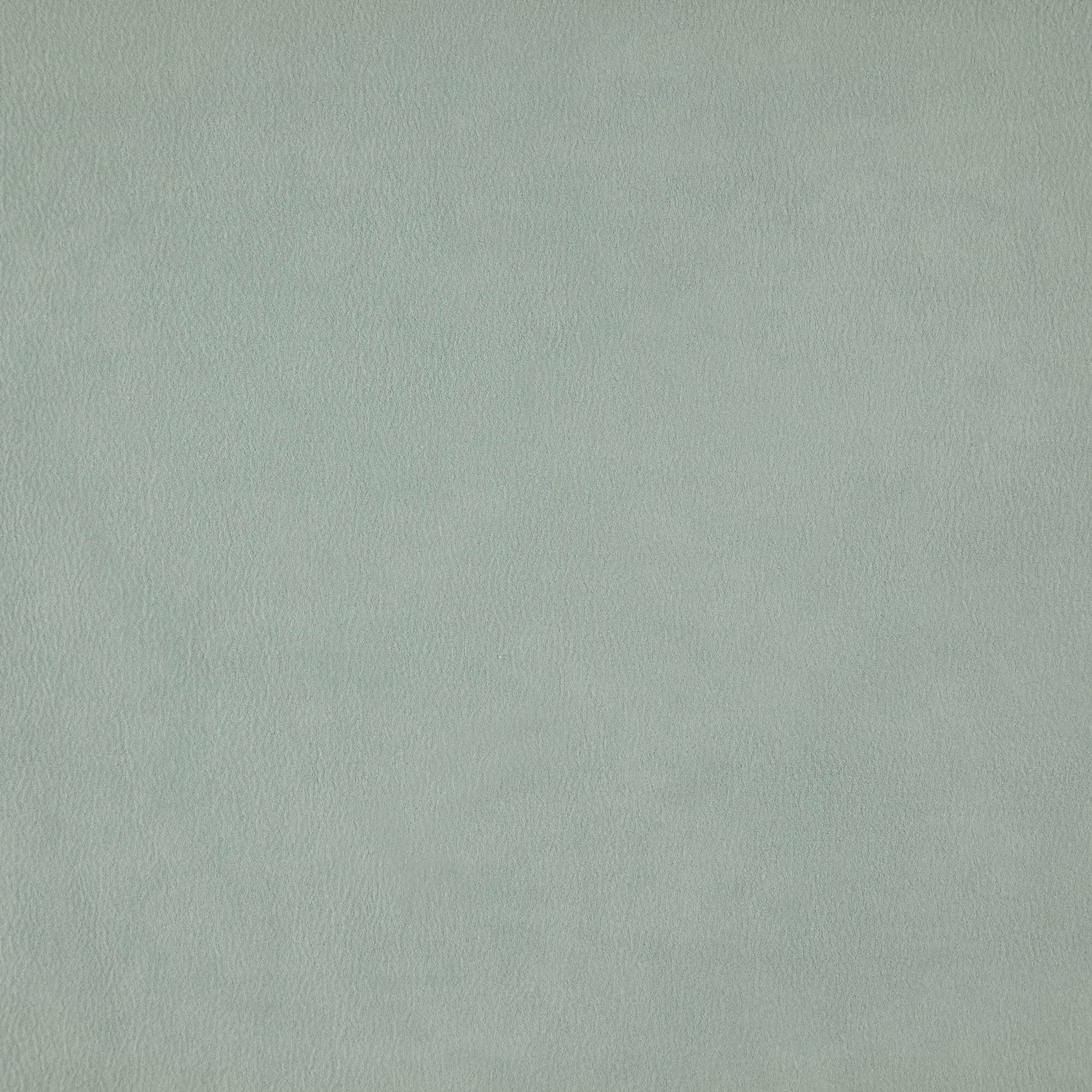 Close-up of blue faux suede texture with soft nap and subtle color variation.