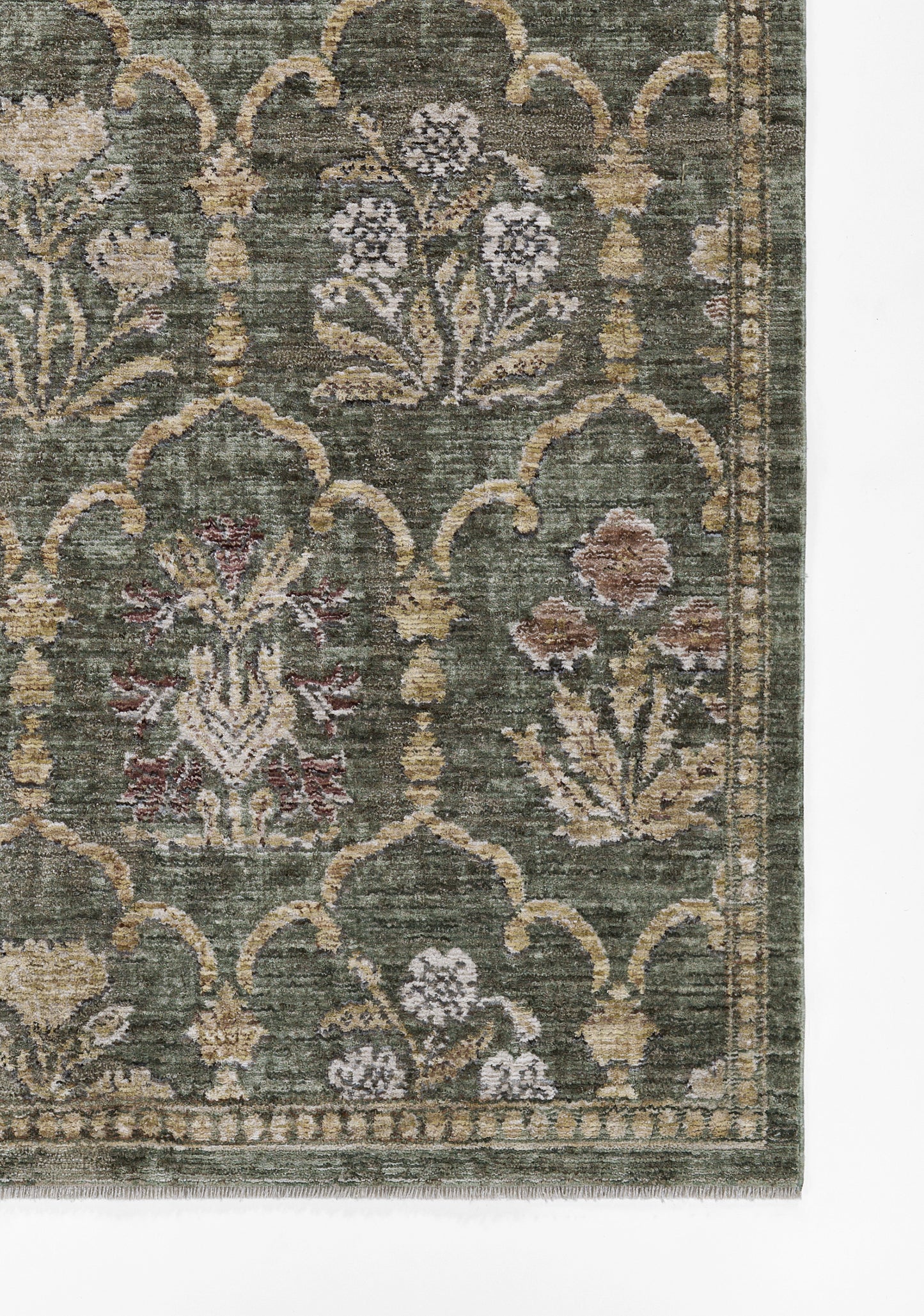 Green oriental rug with cream lattice arches and muted floral motifs in pink, beige and lavender.